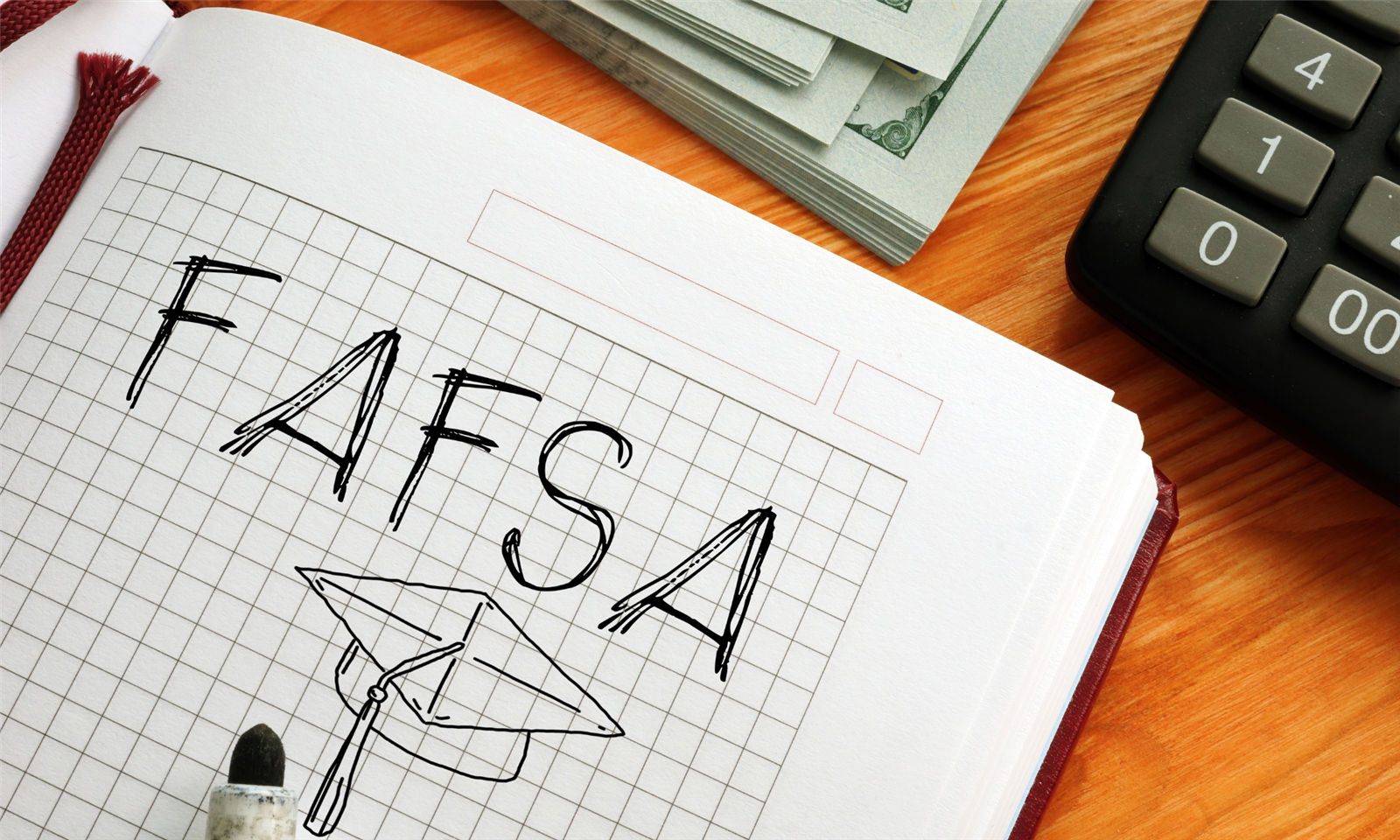 FAFSA written on paper and a calculator